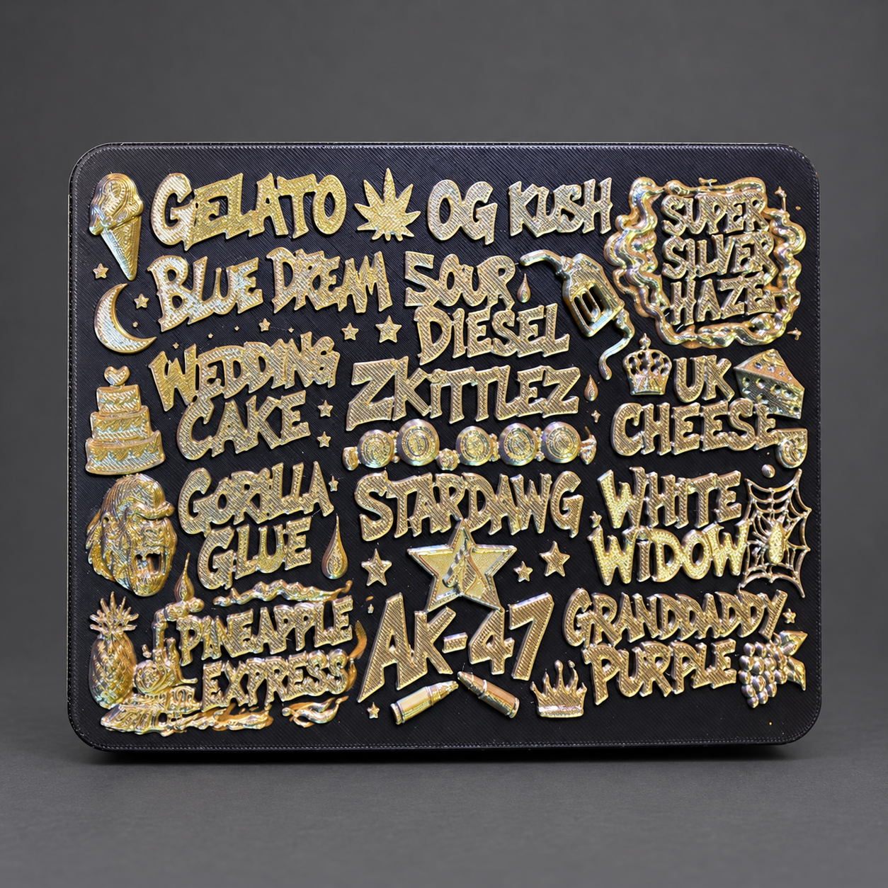 Strain Name Mix #1 tray — A bold collage of strain names in gold on black.